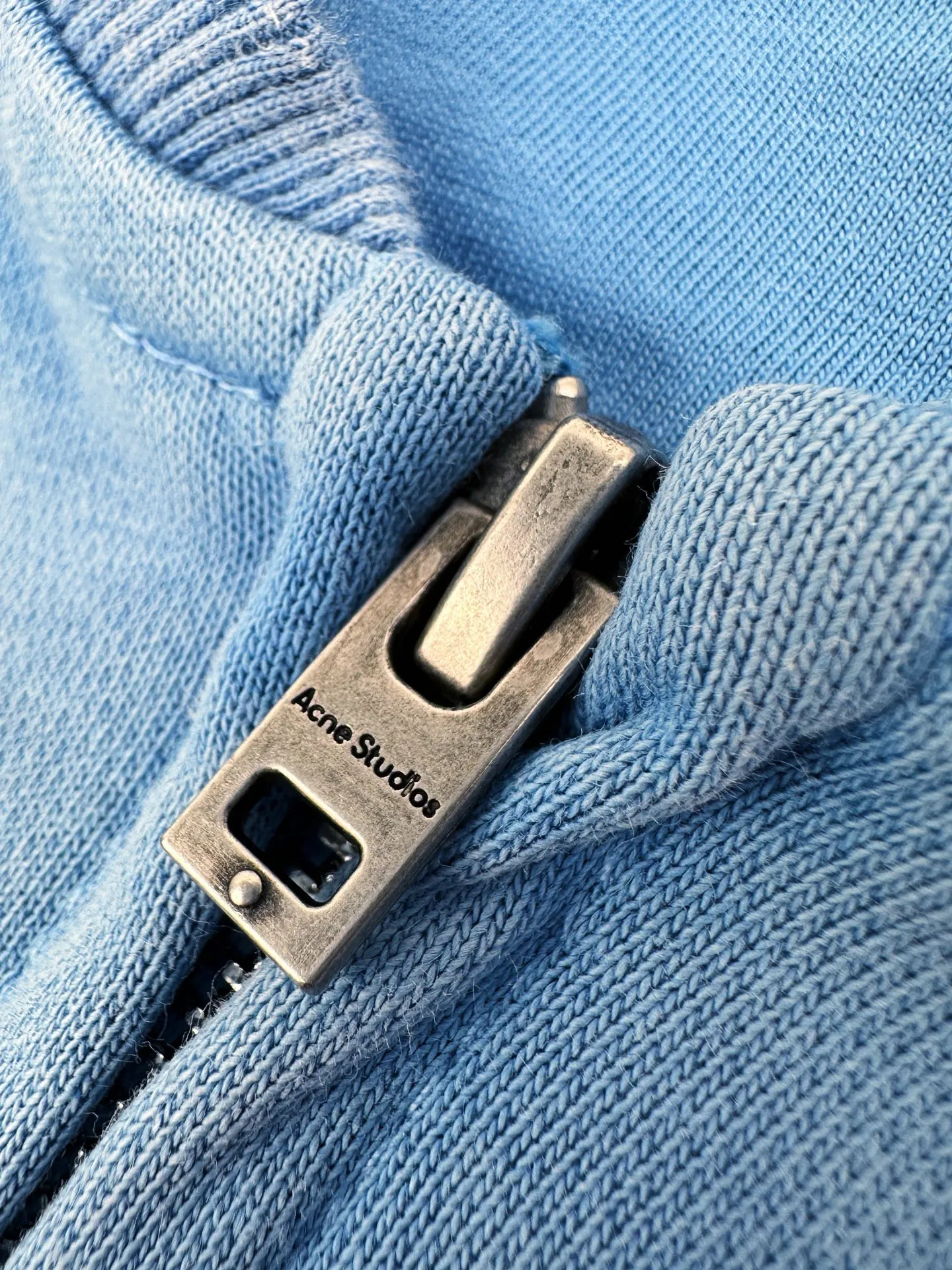 Acne Studios spray-painted distressed logo baseball collar jacket, custom-ordered soft velvet fleece, crisp and smooth, skin-friendly and soft, cornflower blue like clear sky velvet, matte matte flow, warm and luxurious light, showing high-end restrained texture. Classic baseball collar zipper jacket has a neat and noble silhouette. Dropped shoulders are cut for stretch and casualness. Close-woven ribbing shows craftsmanship details. Acne Studios logo printing on the chest. The brand heritage is engraved with Retro sports aesthetics. It is unassuming but highly recognizable. It is a subtle blend of Nordic minimalist style and Retro sports style. It is low-key and elegant with its own aura. Process 1: Adopt glue printing process. The chest printing has been modified three times by the film screen. Use glue liquid paint to print the pattern on the fabric. Bake the fabric to fix the printed pattern. Process 2: Gradient distressed spray-on process. Spray dyes of different colors on the surface of the fabric. Realize that the clothes will show rich color changes under different lights and increase the visual layering. Process 3: Many parts of the body are worn by pure manual regular positioning. Manual brush marks add texture and depth to the surface of the clothing to imitate the texture of natural wear. Process 4: The fabrics have been fermented and washed to have a better hand feel. Not easy to deform, not easy to shrink, not easy to fade, and maintain long-term beauty. Accessories: Customized 1:1 Acne zipper Customized 1:1 Acne trademark Fit: Loose fit Size: S M L XL Style: CC